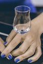 A Glass of Grappa in WomanÃ¢â¬â¢s Hands. Grape Brandy or Schnapps o Royalty Free Stock Photo